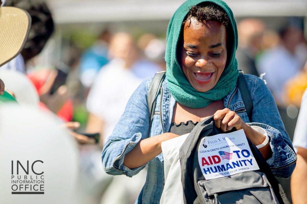 An Oakland resident is excited to see the care package contents at the Oakland Aid to Humanity event.