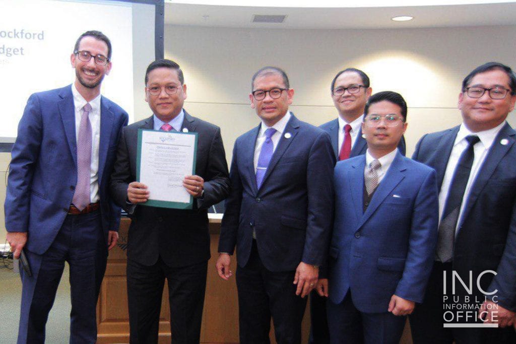 Rockford Mayor McNamara and Minister of the Gospel Brother Eduardo Javier, along with other Ministers, posing with the Certificate of Proclamation